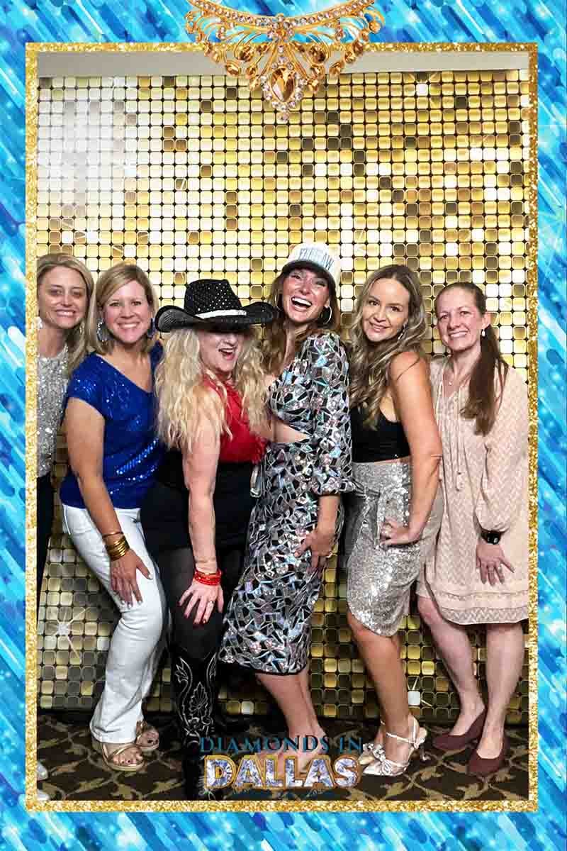 corporate-event-custom-photo-template-dslr-booth Guests posing with a custom one-frame photo template designed to match a corporate event's branding and theme.